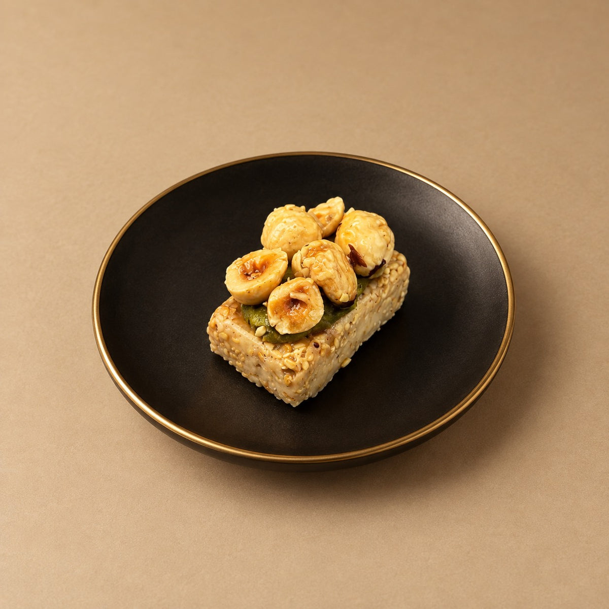 Mignardise rectangulaire au sésame garnie de noisettes